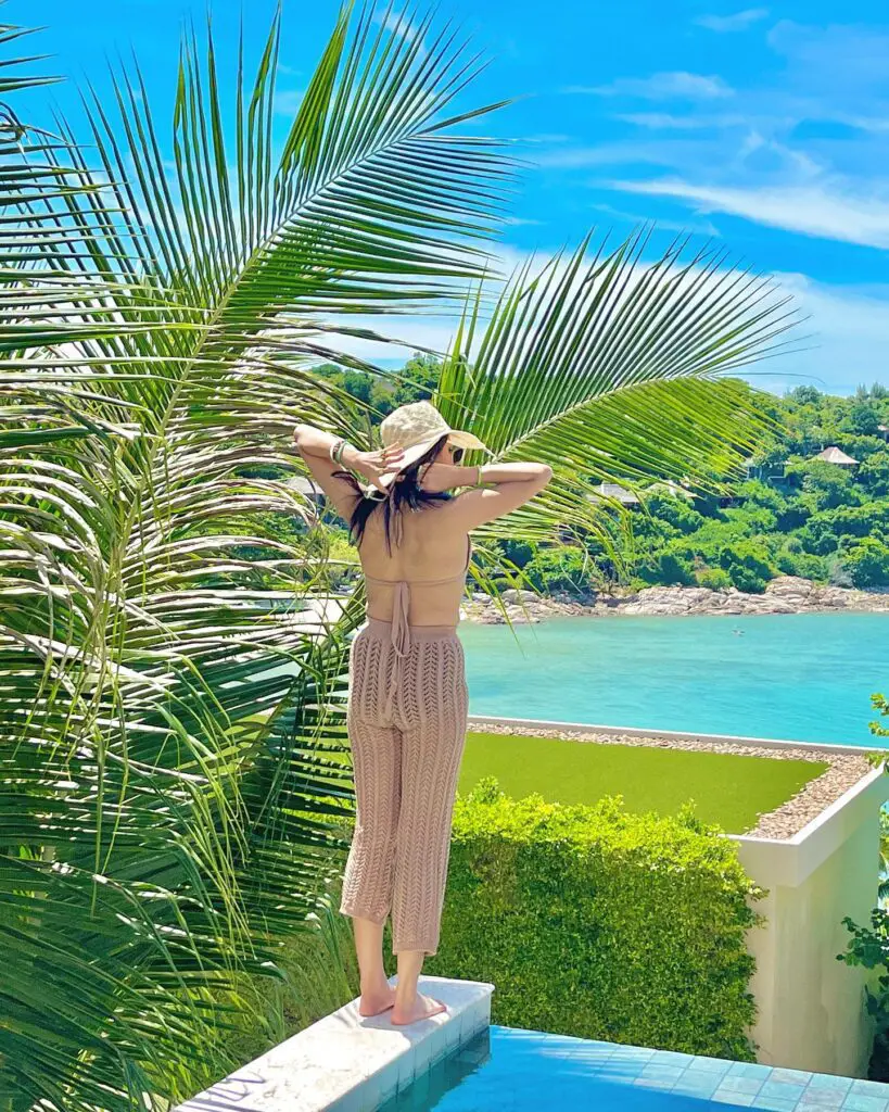 Sharkshe aka Shakshi Shetty enjoying the poolside while sitting on a ledge in a bikini.