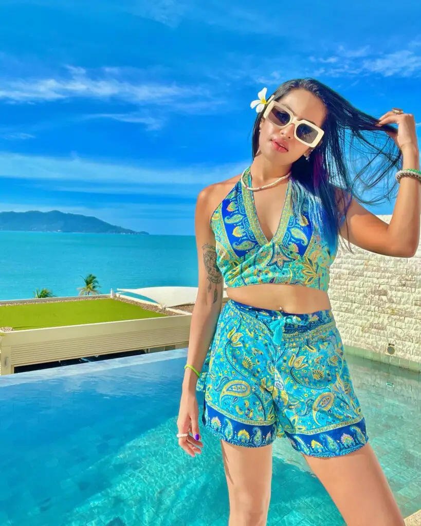 Sharkshe aka Shakshi Shetty looking fashionable in a paisley print swimsuit featuring shades of blue and green.