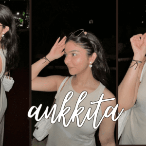 Ankkita C, a woman in a white dress, striking a pose for the camera