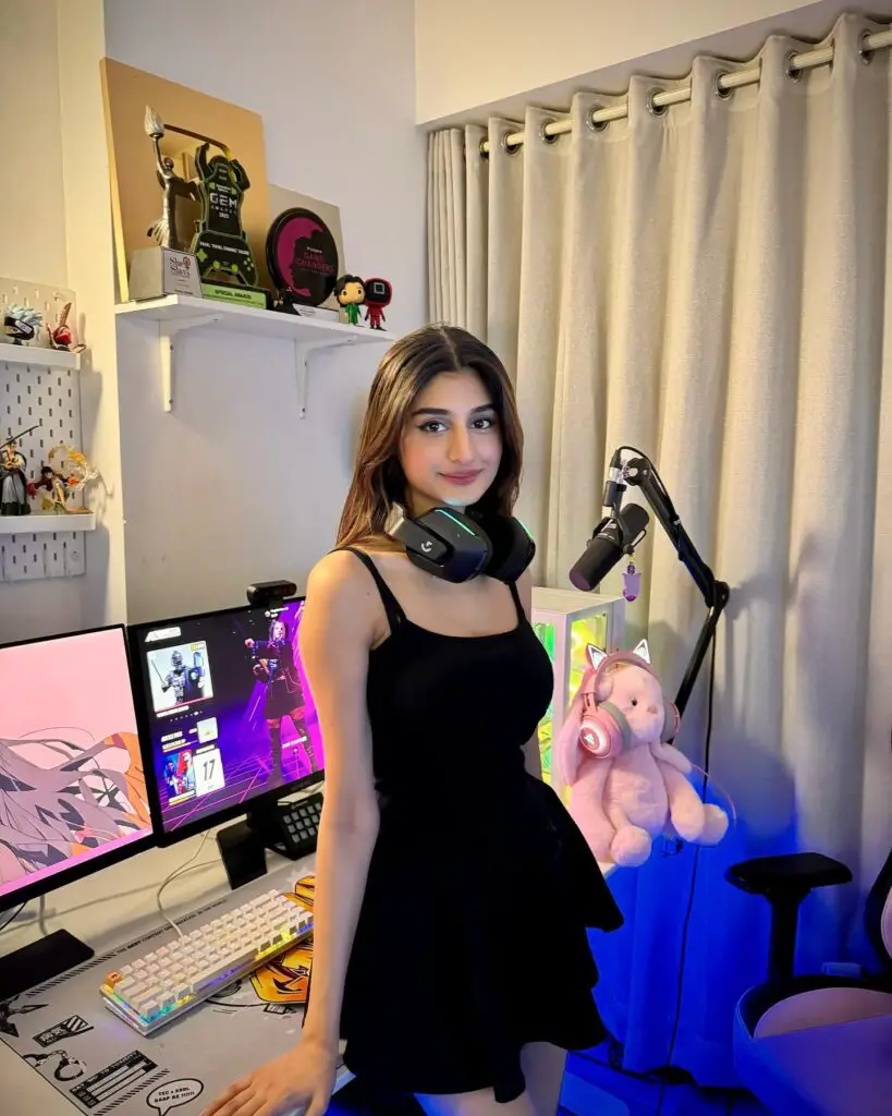 Payal Gaming in a black midi dress in her home